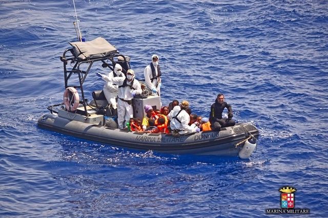 Gerettet: Mitglieder der italienischen Marine bringen Flüchtlinge in Sicherheit (Archiv).